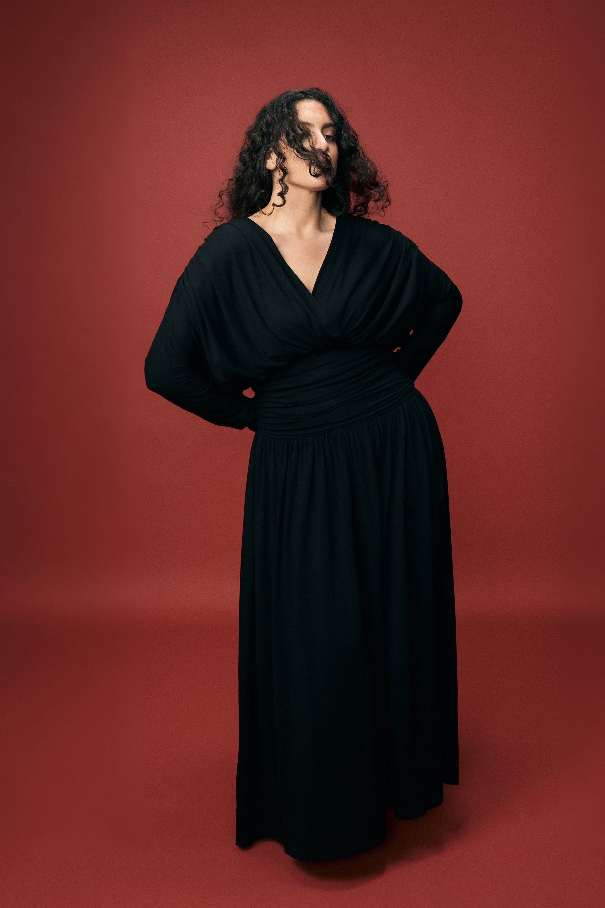 Woman in VIVEH black off-shoulder dress — effortless daily style